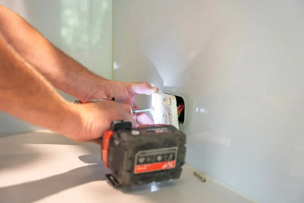 Power point being fitted in a kitchen splashback